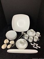 Group of all items together: Palm bowl, 7 dessert plates, matching espresso cup sets with saucers, olive tray, utensil rests, silver spoons, and coral topped napkin rings.