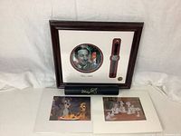 Full view of the lot showing framed watch, empty watch box, and two Disney art prints.