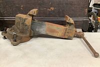 Side view of the heavy cast iron Prentiss Bull Dog Vise showing arm handle and jaw assembly.