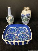 Three pieces including two small Royal Copenhagen porcelain vases and one faience square dish with blue geometric pattern, one vase mounted with sterling silver.