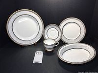 Arrangement showing dinner plate, salad plate, footed teacup with saucer, and oval vegetable dish