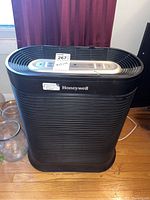 Front view of the Honeywell air purifier showing the control panel and branding.