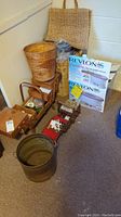Overall view of wicker hampers, bags, sewing cases, and boxed Revlon Spa paraffin bath