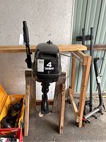 Front view of APS outboard motor mounted on wooden stand