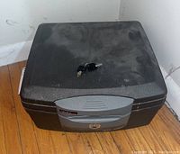 Closed black Sentry Safe with keys placed on top.