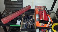Socket set, screwdriver selection, and handsaw boxes on shelf