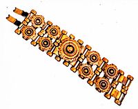 Bracelet laid flat, showing the full length and decorative circular gears in brass and copper tones.