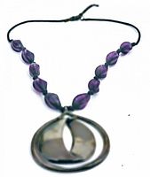 Front view of necklace showing amethyst glass beads and nephrite pendant on black cord.