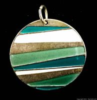 Front side of the reversible enamel pendant showing horizontal enamel stripes in turquoise, white, light green, and teal separated by silver-tone metal.