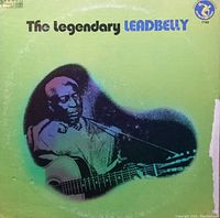 Front view of album cover for 'The Legendary Leadbelly' 1973 US pressing stereo jazz record, showing green cover with black and purple graphic of Leadbelly playing guitar and visible edge wear.