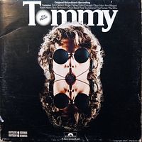 Front cover photo showing the 'Tommy' album artwork by The Who, with visible wear and age marks on the jacket.