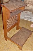 Front view of the solid oak prayer bench showing lattice back and kneeling step
