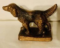 Side view of the copper color Pointer Spaniel dog figurine showing detailed texture and stance.
