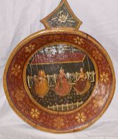 Front view of the hand painted wooden bowl showing three Punjabi women in traditional attire and floral border.