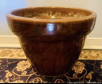 Front view of large brown glazed pottery planter showing shape, finish and condition