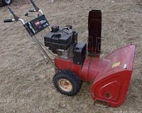 Side profile view showing overall unit, engine, housing and chute.