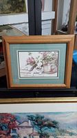 Front view of framed bunny print wall art with visible oak frame and green matting.