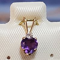 Front view of heart-shaped amethyst and round white topaz pendant in 10K yellow gold.