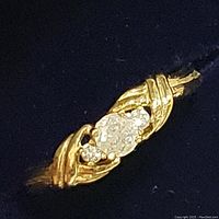 Close‐up of ring center showing three round diamonds set in twisted rope motif