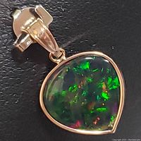Front close-up of the opal pendant showing play-of-color and setting