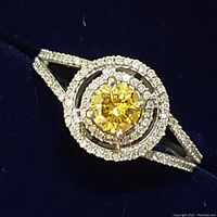 Front view of ring showing yellow diamond and double halo