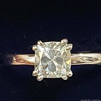 Close-up front view of the sterling silver ring with cushion-cut moissanite stone, showing the detail of the stone and prong setting.