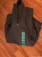 Folded hoodie showing XL size label on sleeve.