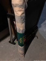 Photo of the hammock in a white carry bag with a green label reading 'hammock hamac'.