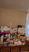 Overview of bathroom supplies on furniture including toilet paper, bar soap, shampoo, toothpaste, tissues, and others.