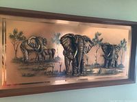 Frontal view of the entire wood-framed 3D copper elephant wall art