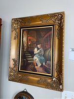 Full view of the framed painting showing a man in robe seated in wine cellar setting.
