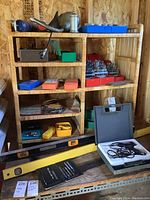 Wicker shelf with assorted tools and levels on table