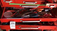 Photo of two red metal drawers open showing assorted hand tools inside including pliers, scissors, wrenches, and sockets.