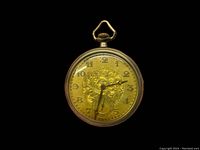 Front view of the watch showing the engraved gold-tone dial with Arabic numerals and subdial.