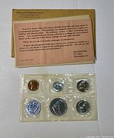 Photo of the six proof coins in sealed plastic envelope and original note from U.S. Mint.