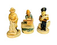 Front view of three fishing-themed Sebastian miniature figurines