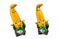 Front view of the pair of corn guy salt and pepper shakers showing facial details, colors, and holes at the top for dispensing.