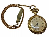 Full view of Bulova pocket watch attached to gold-tone chain with small pocket tool