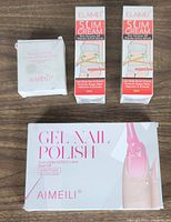 Photo showing two Aimeli Slim Cream boxes each 60ml and a box of six Aimeli Gel Nail Polish bottles for curing under LED/UV lamp.
