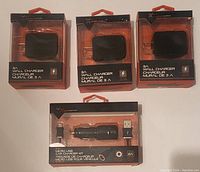 Photo showing three Blackweb 3A wall chargers and one Blackweb micro USB car charger kit, all in original packaging.