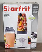 Box of Starfrit personal blender showing brand, model, and images of the blender with food inside blending cups.
