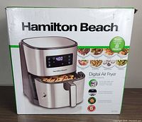 Box packaging of Hamilton Beach Digital Air Fryer showing product image and features including 5.9-quart capacity, 8 presets, and touchscreen control.