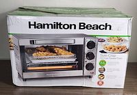 Box of Hamilton Beach Sure-Crisp Air Fryer Toaster Oven showing product image and branding.
