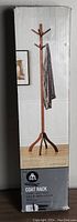 Photo of the coat rack in box with a scarf hanging on the hooks, showing overall design and color.