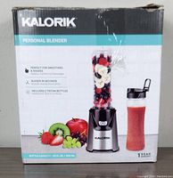 Box with Kalorik personal blender branding and features including bottle capacity and usage for smoothies and shakes