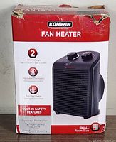 Box showing Konwin fan heater branding and features such as 2 heat settings, adjustable thermostat, fan only option, safety features, and small room size.