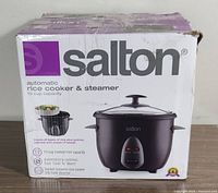 Box of Salton 10 cup automatic rice cooker and steamer showing brand and product details, including 10 cup capacity and features.