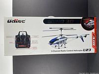 Box showing remote control and helicopter illustration with labeled features