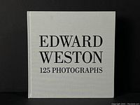 Front cover of the book titled 'EDWARD WESTON 125 PHOTOGRAPHS' in black font on a light grey hardcover.