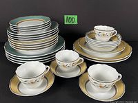 Full view of stacked plates, cups, and saucers showing the overall set contents and decoration